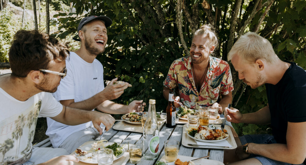 Fyra vänner äter mat i naturen. Foto: Alexander Hall/Älmhults kommun