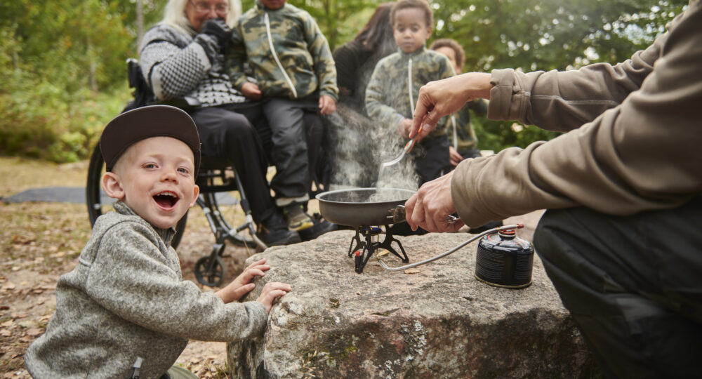 Barnfamilj grillar utomhus i naturen. Foto: Älmhults kommun