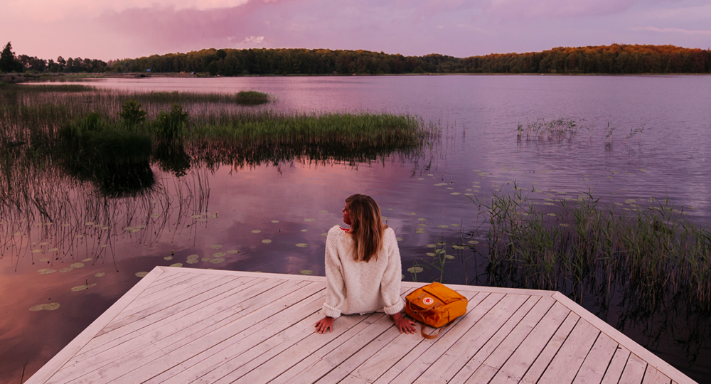 Woman by a lake in the sunset.